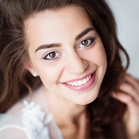 A woman with brown hair smiling.