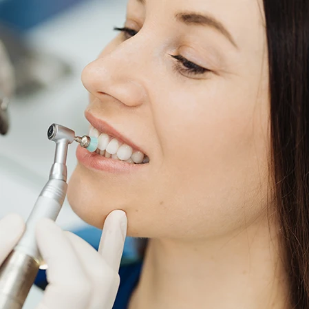 A woman getting her teeth polished.